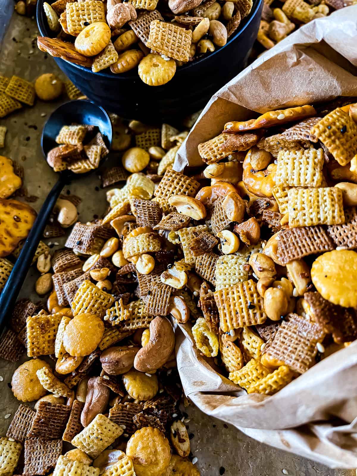up close picture of a bag of snack mix with pretzels, cereal, nuts, and oyster crackers