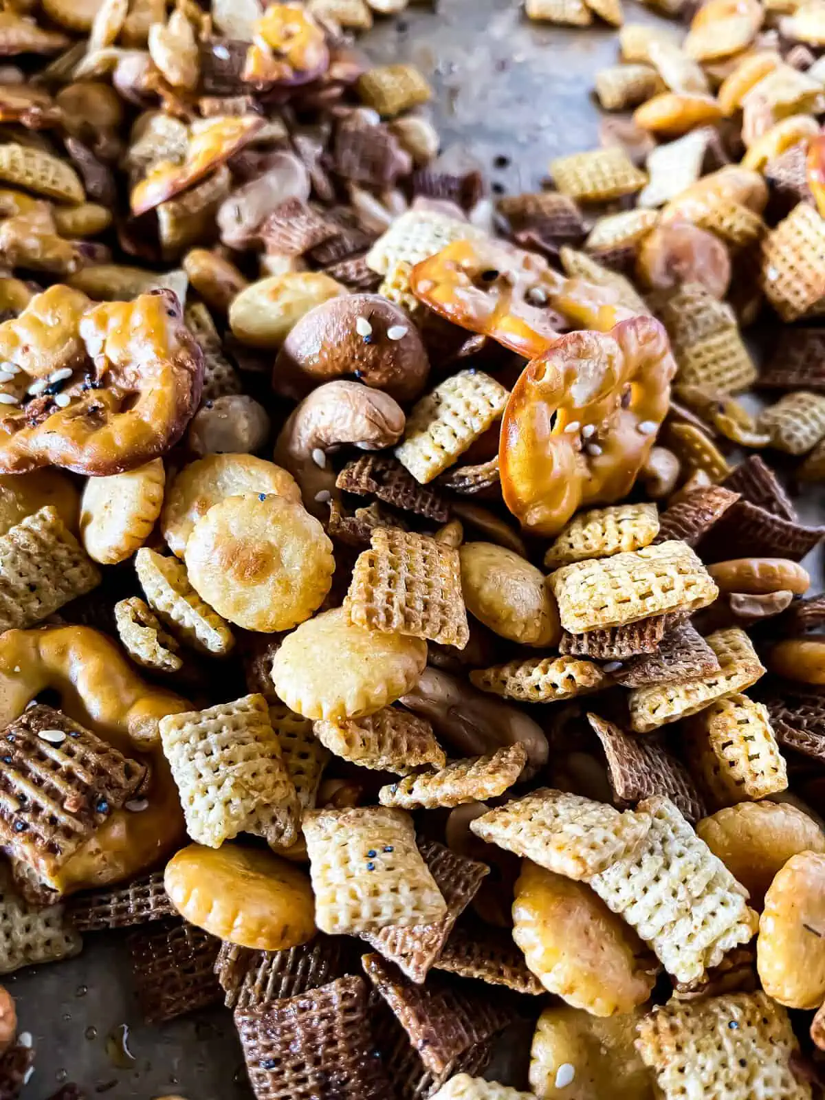 Up close picture of savory snack mix recipe with pretzels, cereal, nuts, and oyster crackers