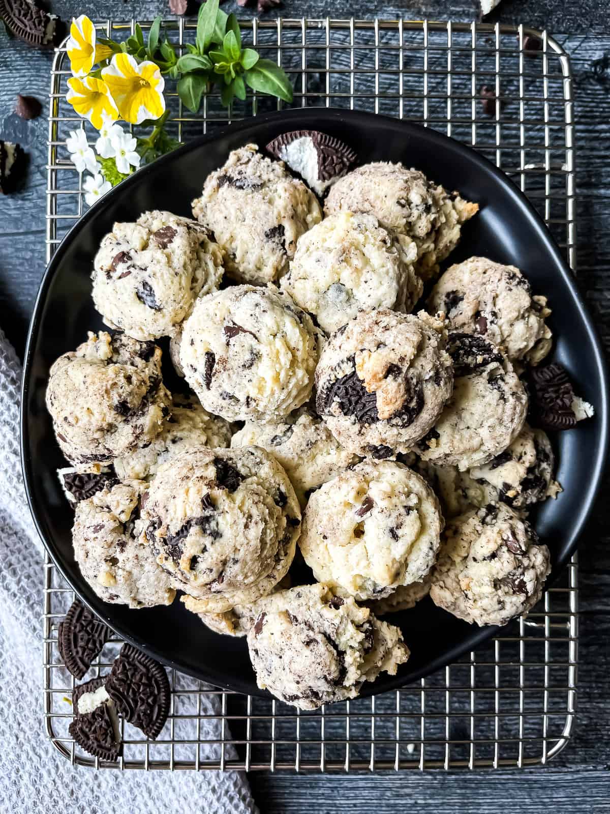 Chocolate Cream Cheese Crunch Cookies with cookie and chocolate garnishes. Flowers for decoration.