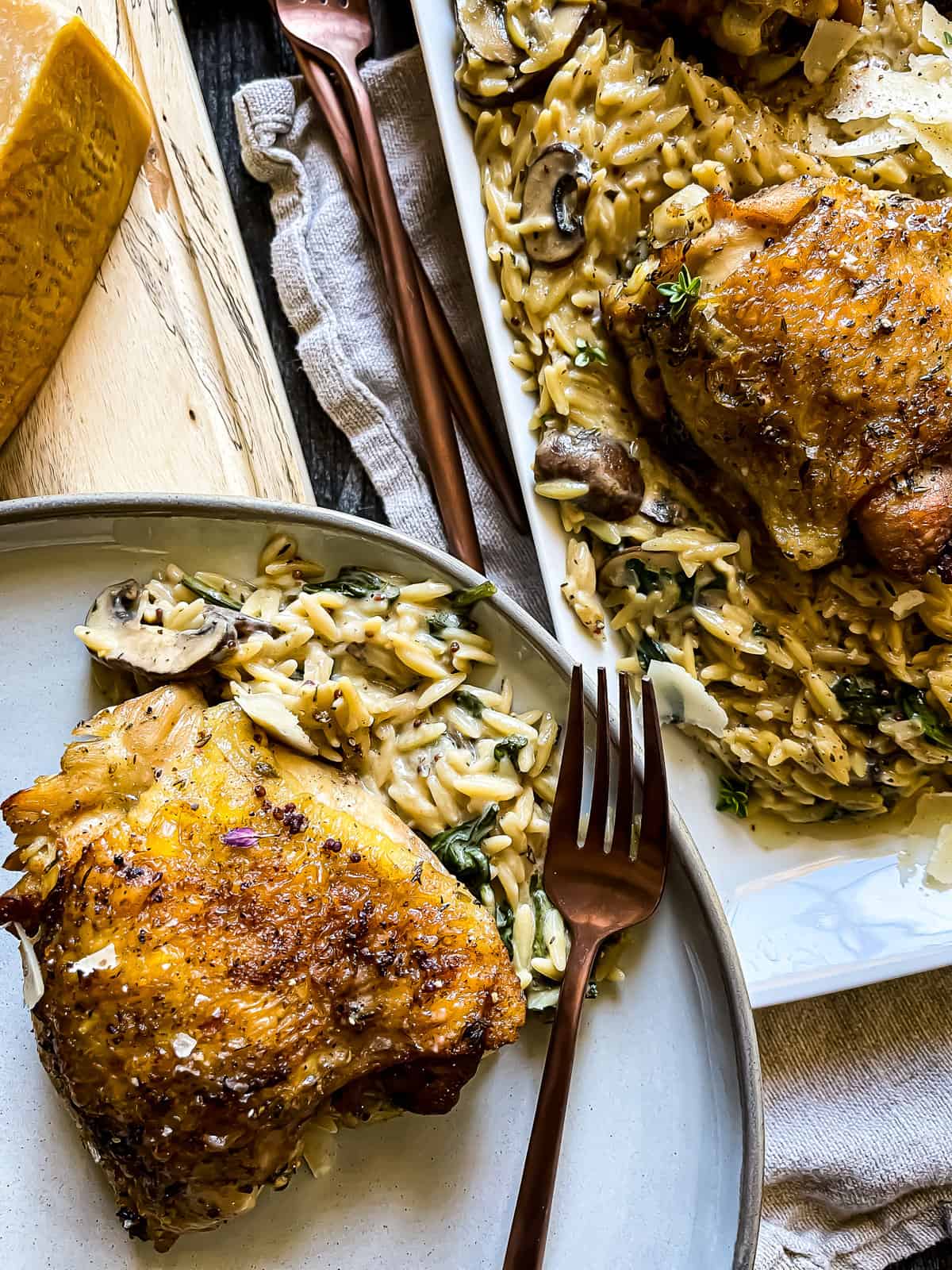 plate of instant pot mustard cream with orzo with parmesan wedge and serving platter nearby